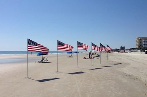 American flags line the beach in New Smyrna Beach, Florida on Memorial Day / Headline Surfer®