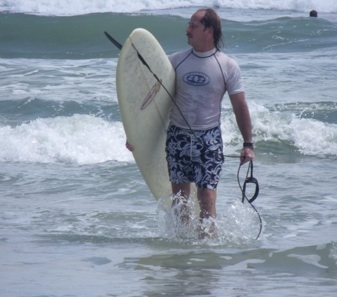 Surfer due in New Smyrna Beach near the South Jetty at high tide / Headline Surfer