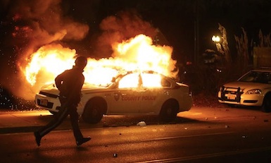 Cop car on fire in Ferguson, MO / Headline Surfer®
