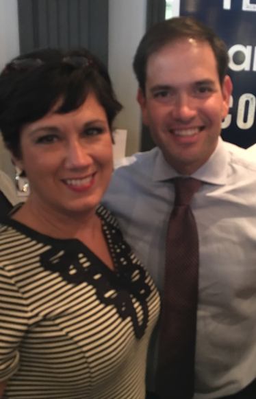 Shelly Vincent of New Smyrna Beach posdes with Marco Rubio at a campaign stop in Port Ora nge, FL