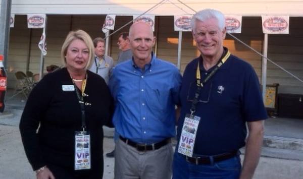 Gov Scott is flanked by Volusia Councilwoman Deb Denys and SEV Ad Authority Director Carl Watson / Headline Surfer®
