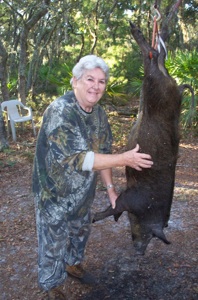 Linda Hyatt, a former Oak Hill vice mayor and city commissioner is an avid hunter shown here with a wild board she snared / Headline Surfer®