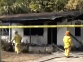 Firefighters assess damage following fatal house fire in NSB / Headline Surfer®
