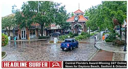 Pedestrians dodge the rai Monday in Winter Garden, FL / Headline Surfer